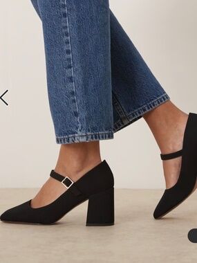 Mary Jane black mid-block heeled shoes.
